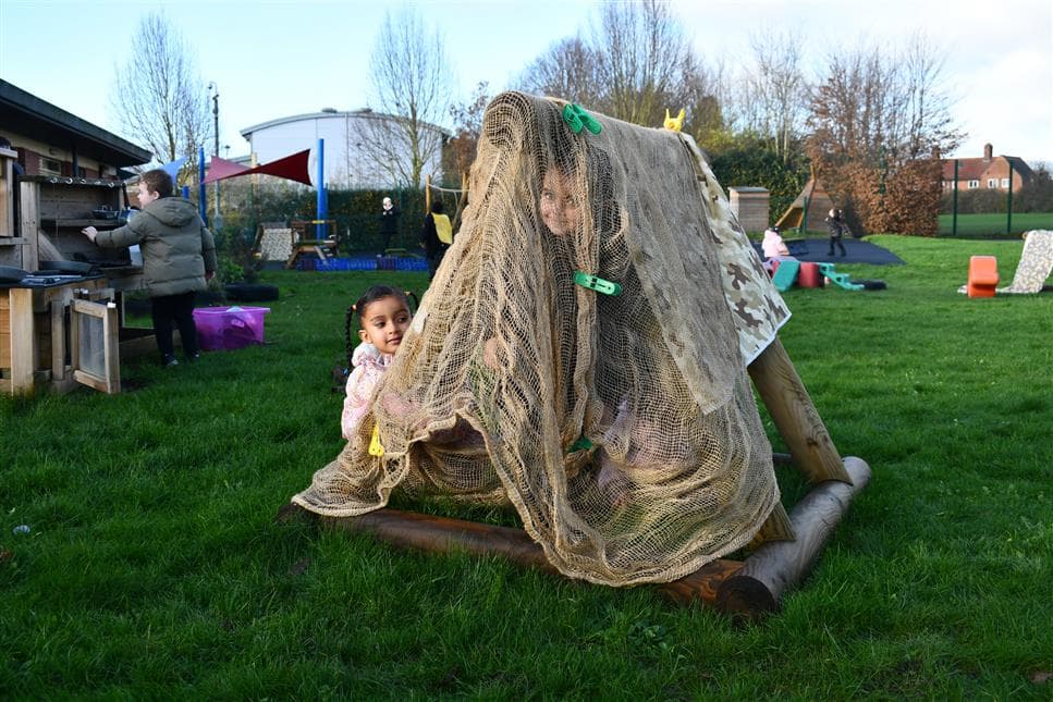 A class of children making a den out of the sen play product