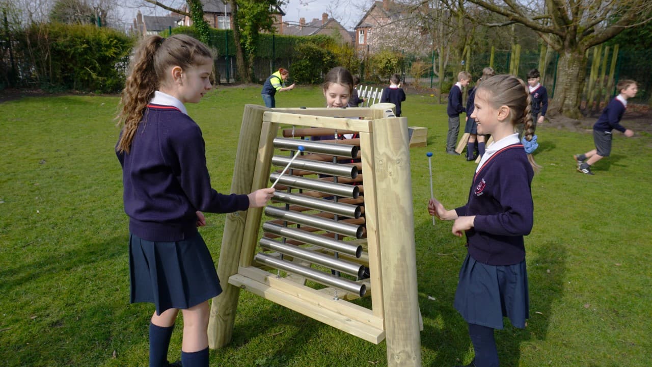 three little girls play around on the triad