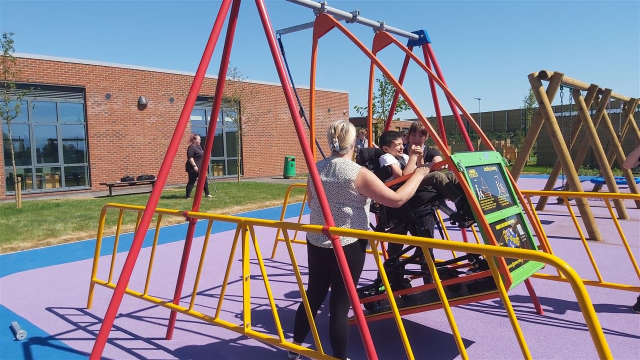 a child playing on our wheelchair swing