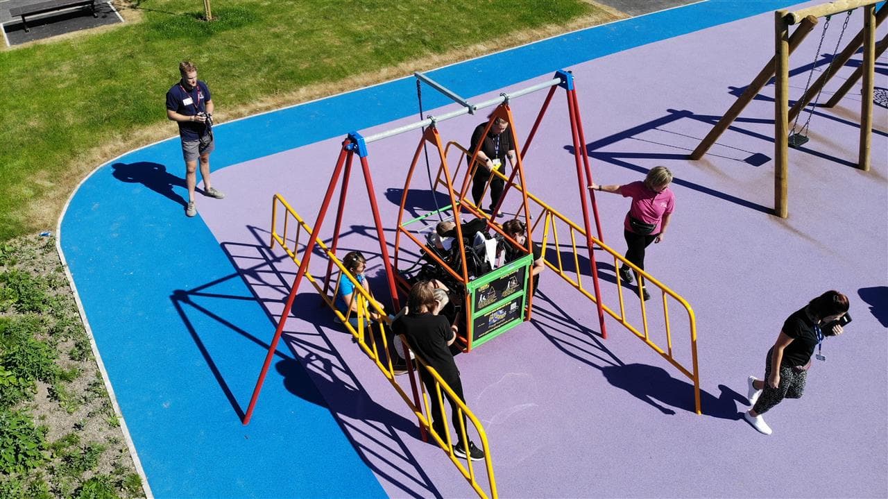 children playing on the wheelchair swing