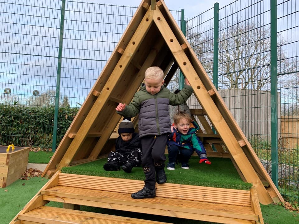 learning den with artificial grass surfacing