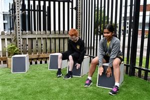 children using drum seats in their playground
