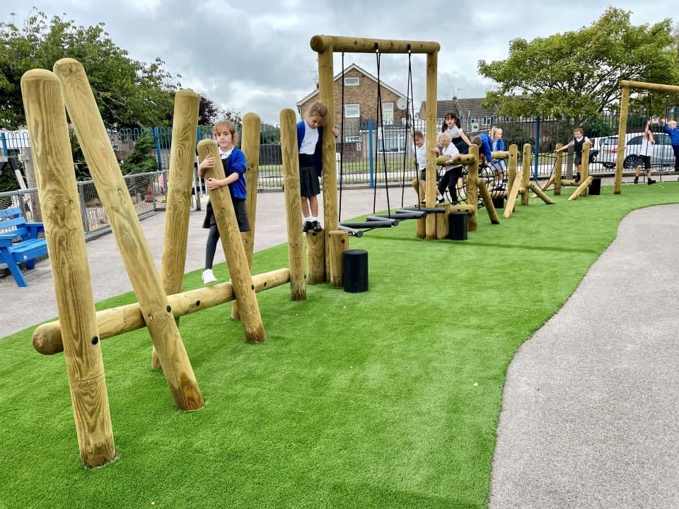 children crossing the log incline beams