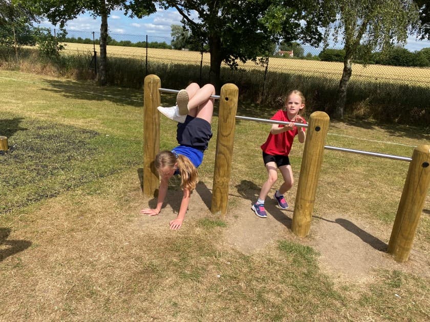Children build their upper and lower body strength on the rollover bars