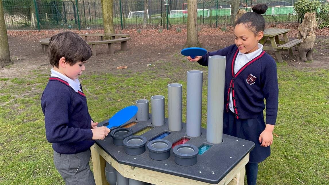 2 children using the Batonka musical instrument at their primary school