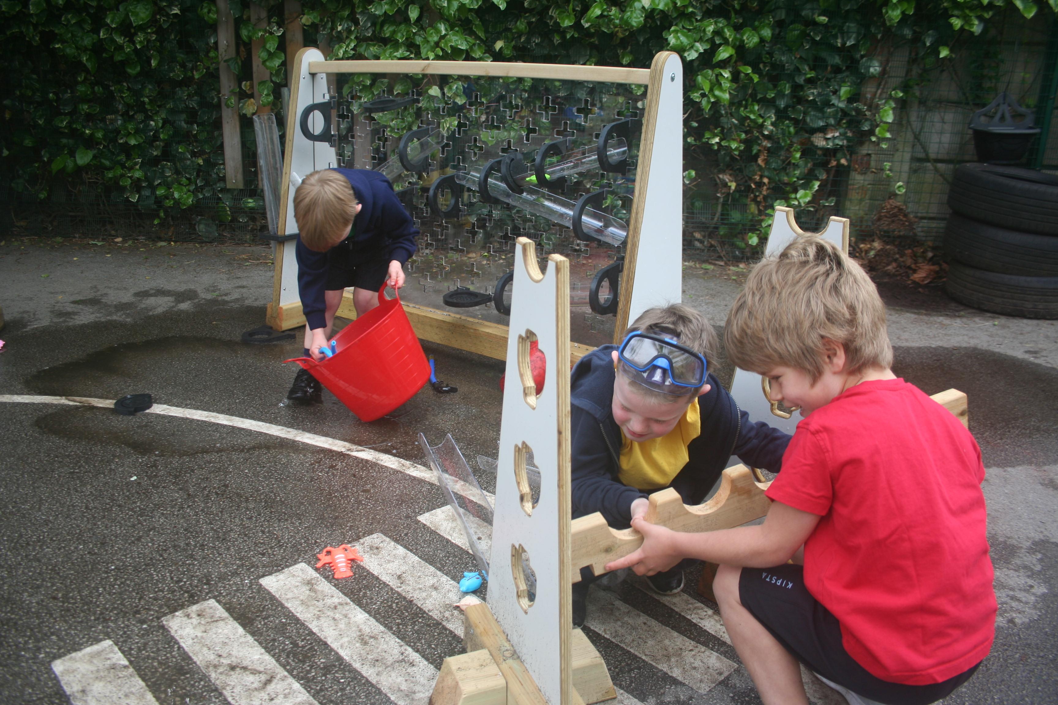 Two children placing together the Water Channel Stands 