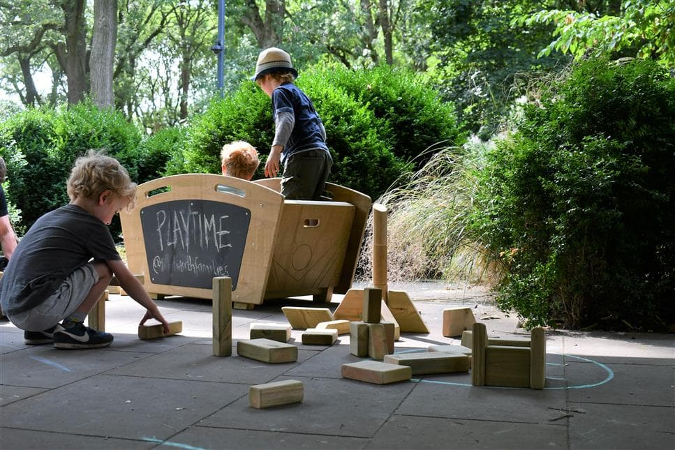 A young boy playing with the blocks from the skip