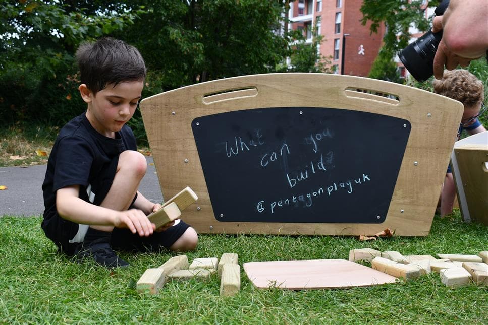 A boy playing with the blocks from the maxi skip