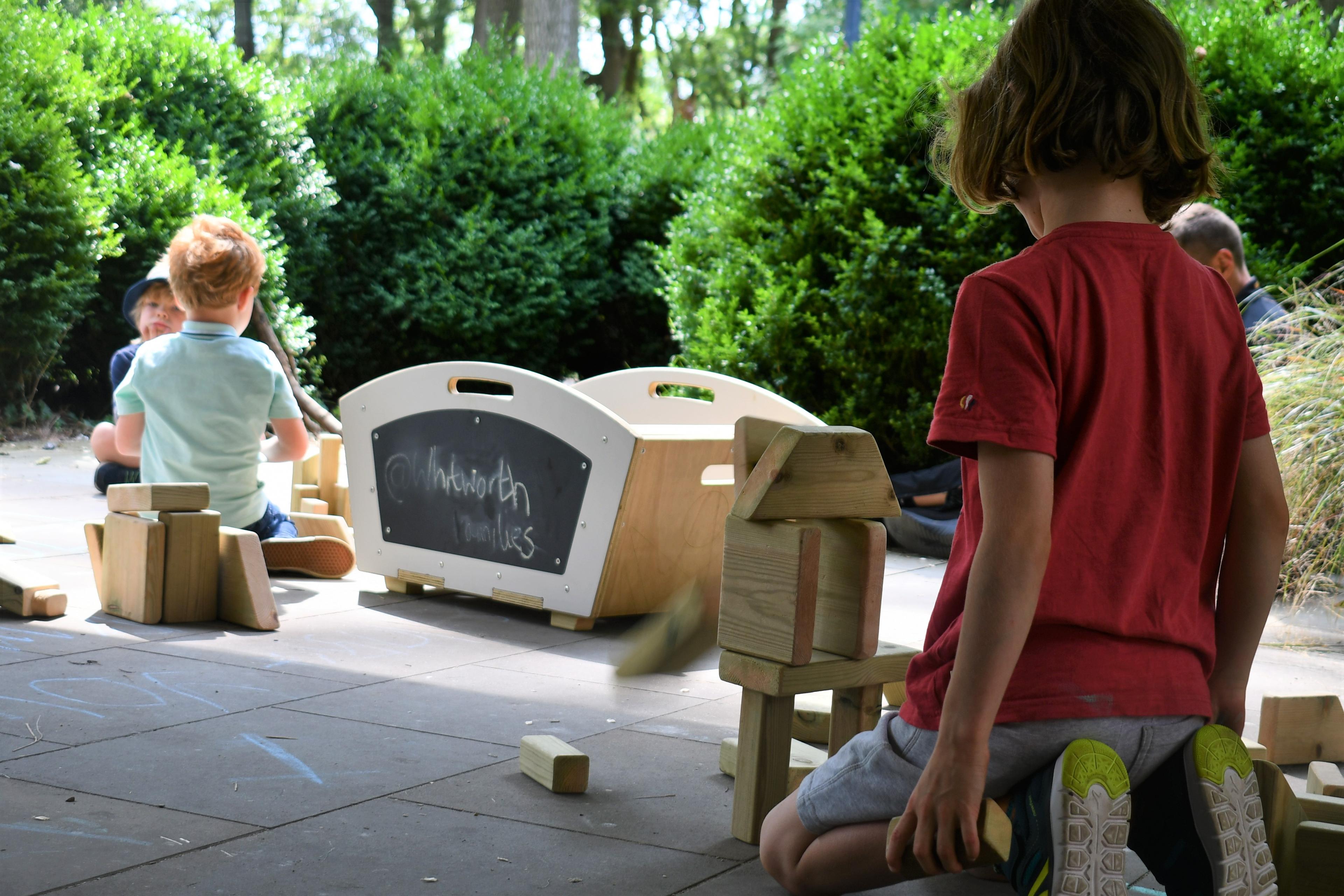 Children playing with the blocks from the mini skip