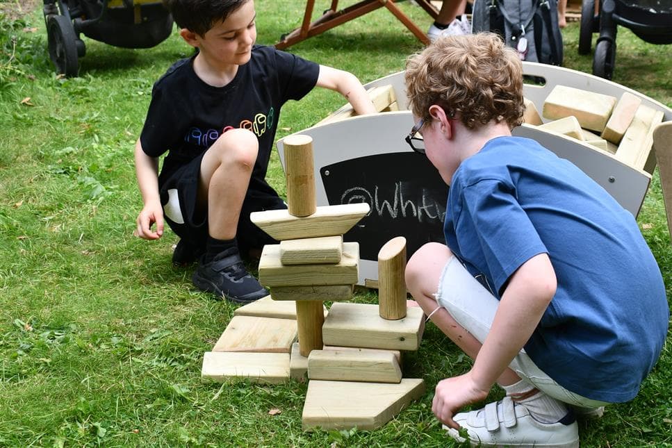 two boys playing with the blocks for the skips
