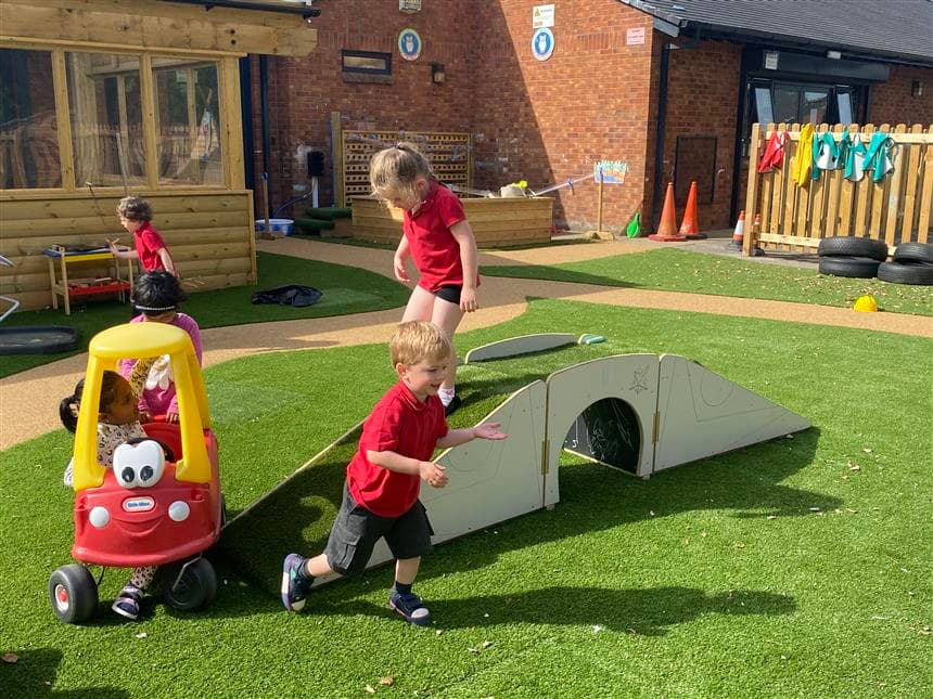 2 eyfs children playing on the up and under bridge 