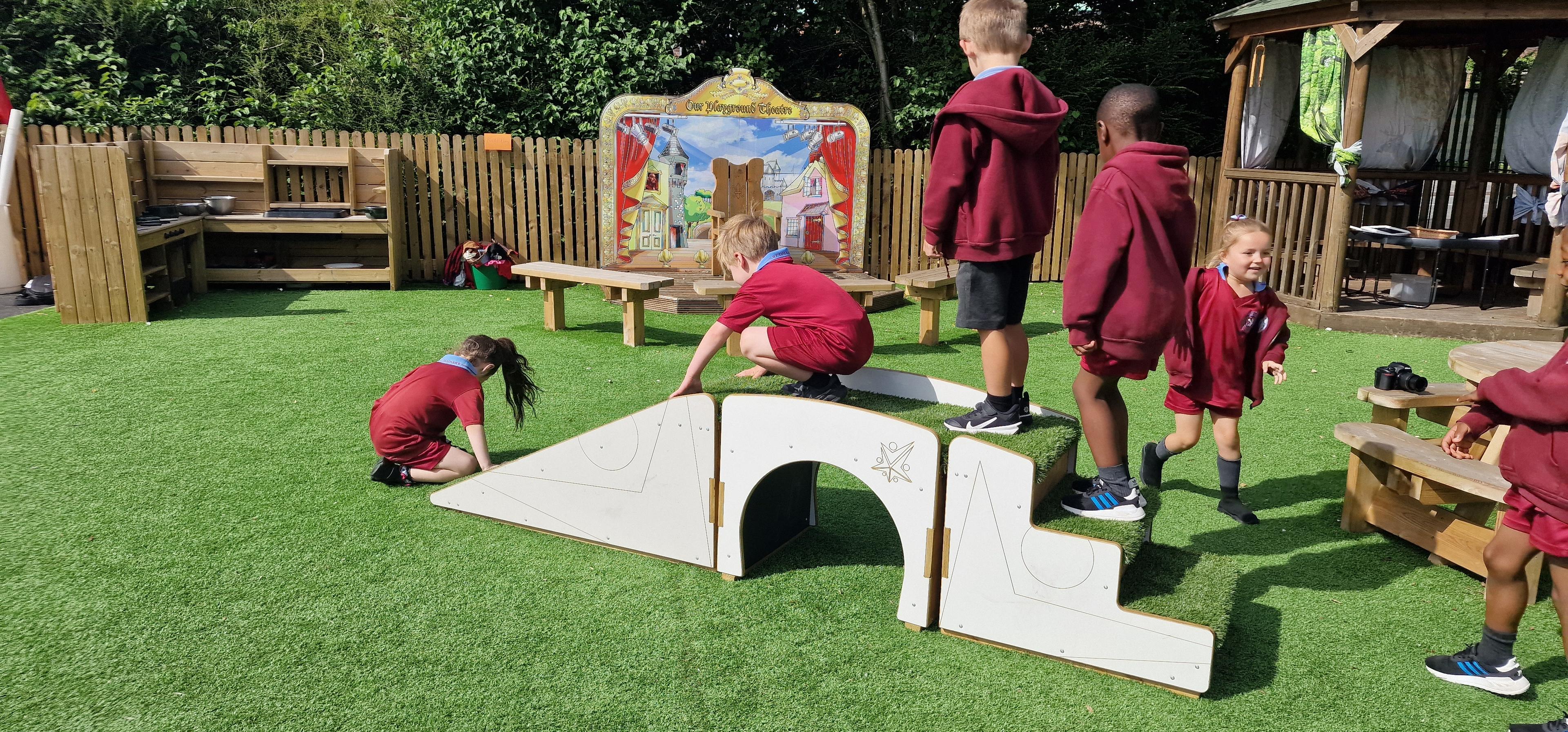 A class of children playing on the play bridge