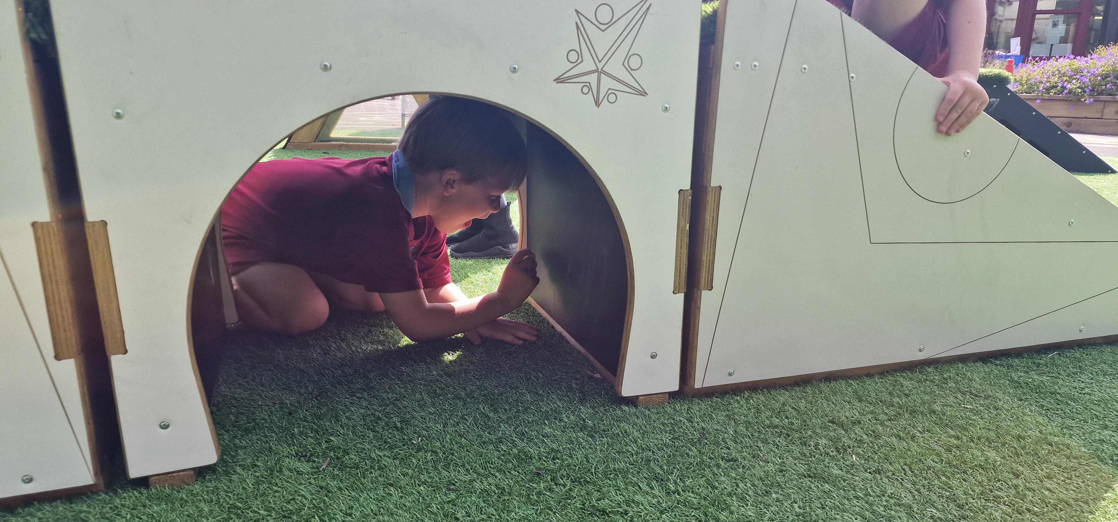 A young boy drawing under the movable blocks