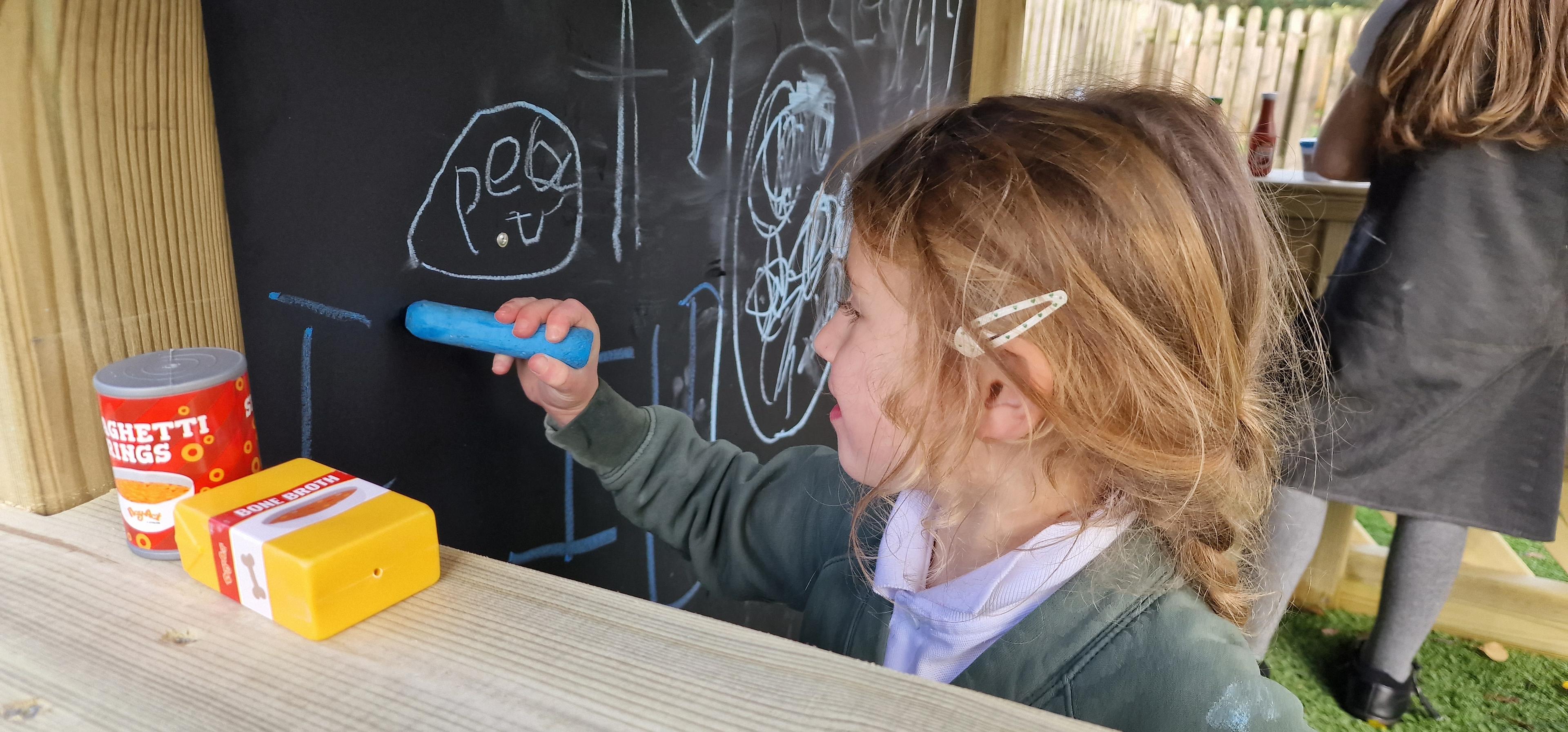 A close up of children playing in the small playhouse