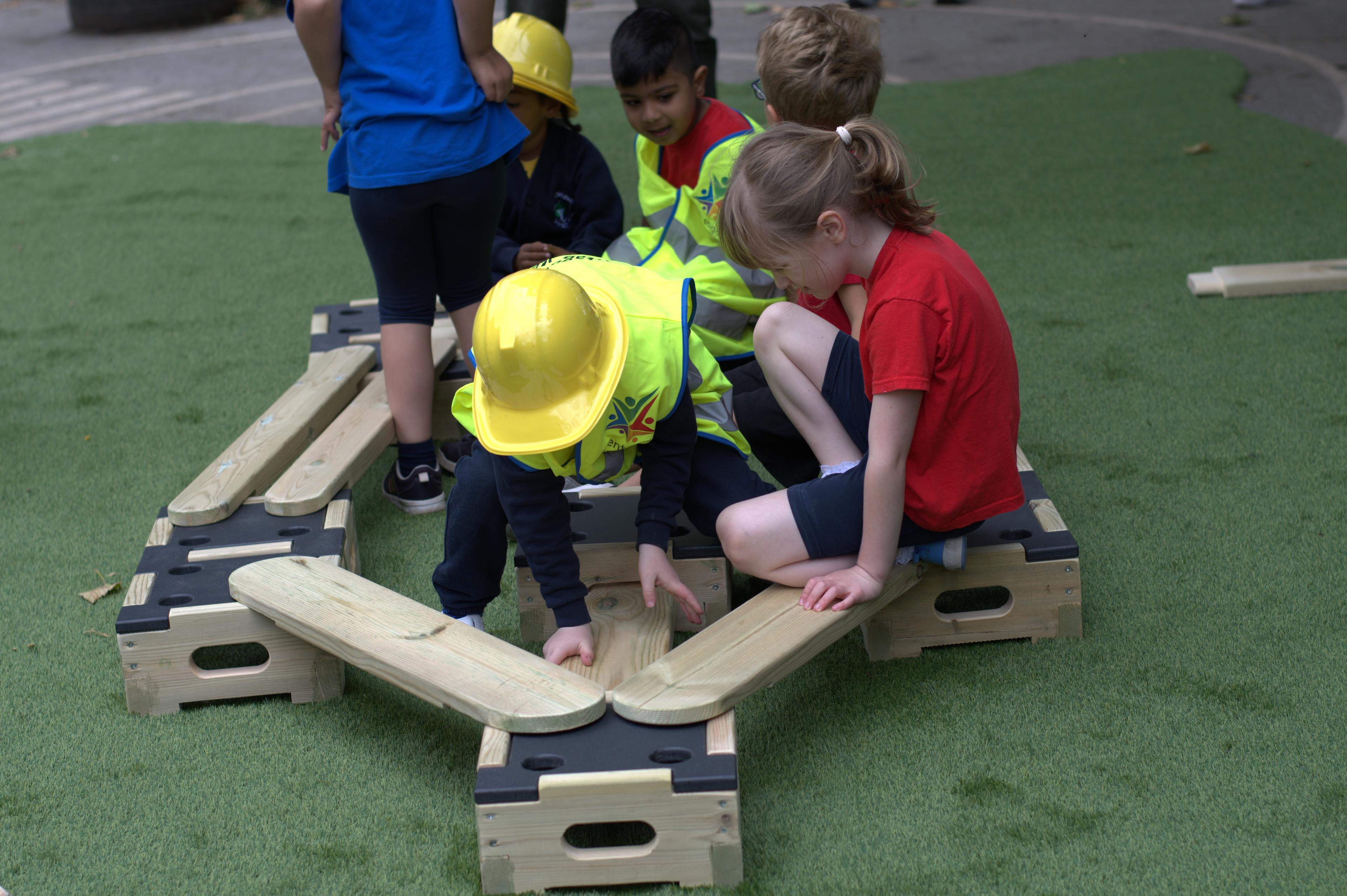 children creating a trail out of the play builder set