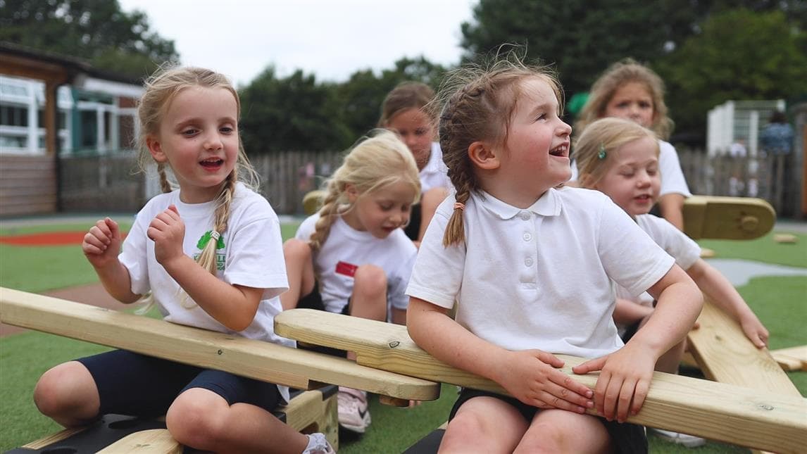 5 girls pretending to to use the play builder as a plane