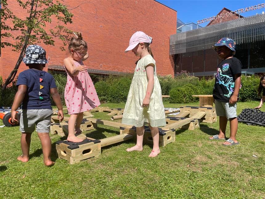 4 children playing on the play builder blocks 