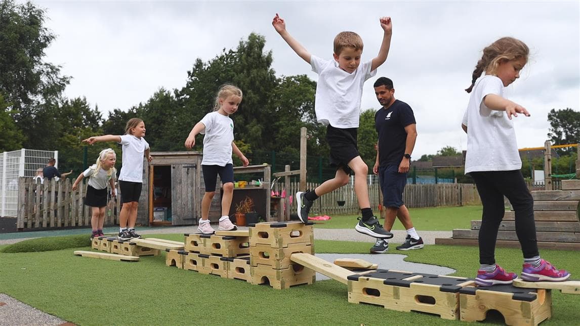 5 children walking across their trail they have made from the engineer play builder set