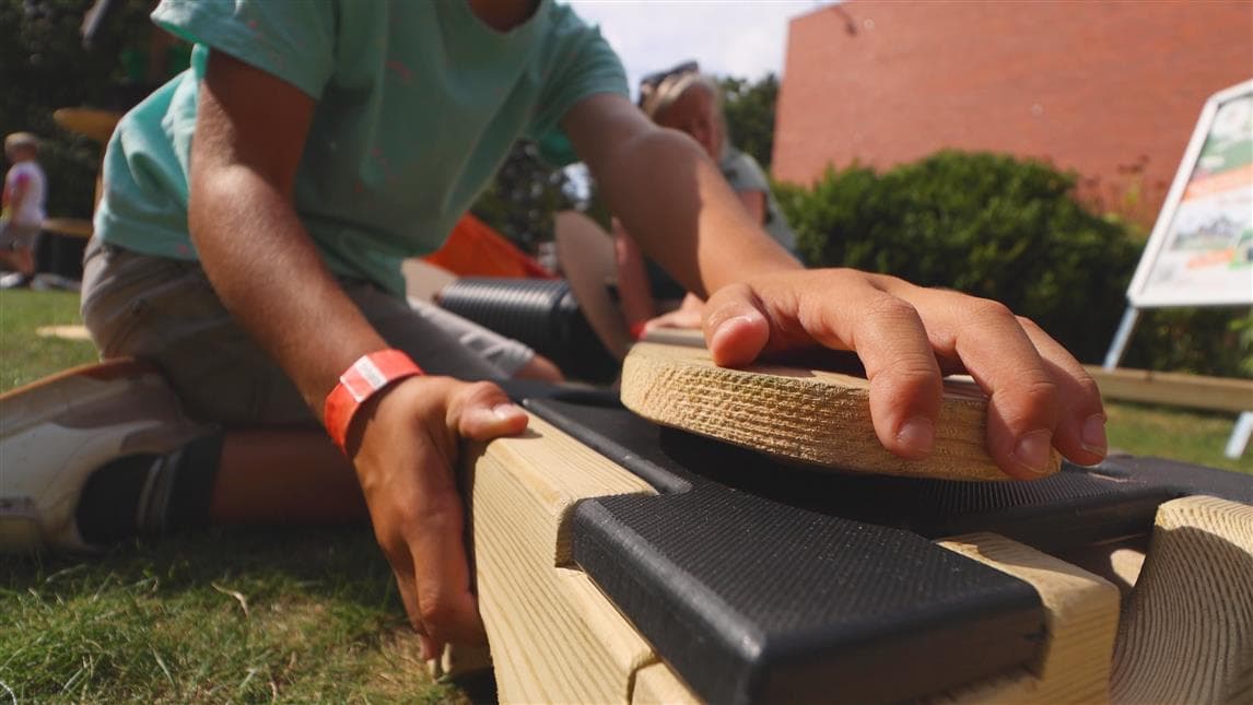A close up shot of young boy slotting the plank on top of the play builder