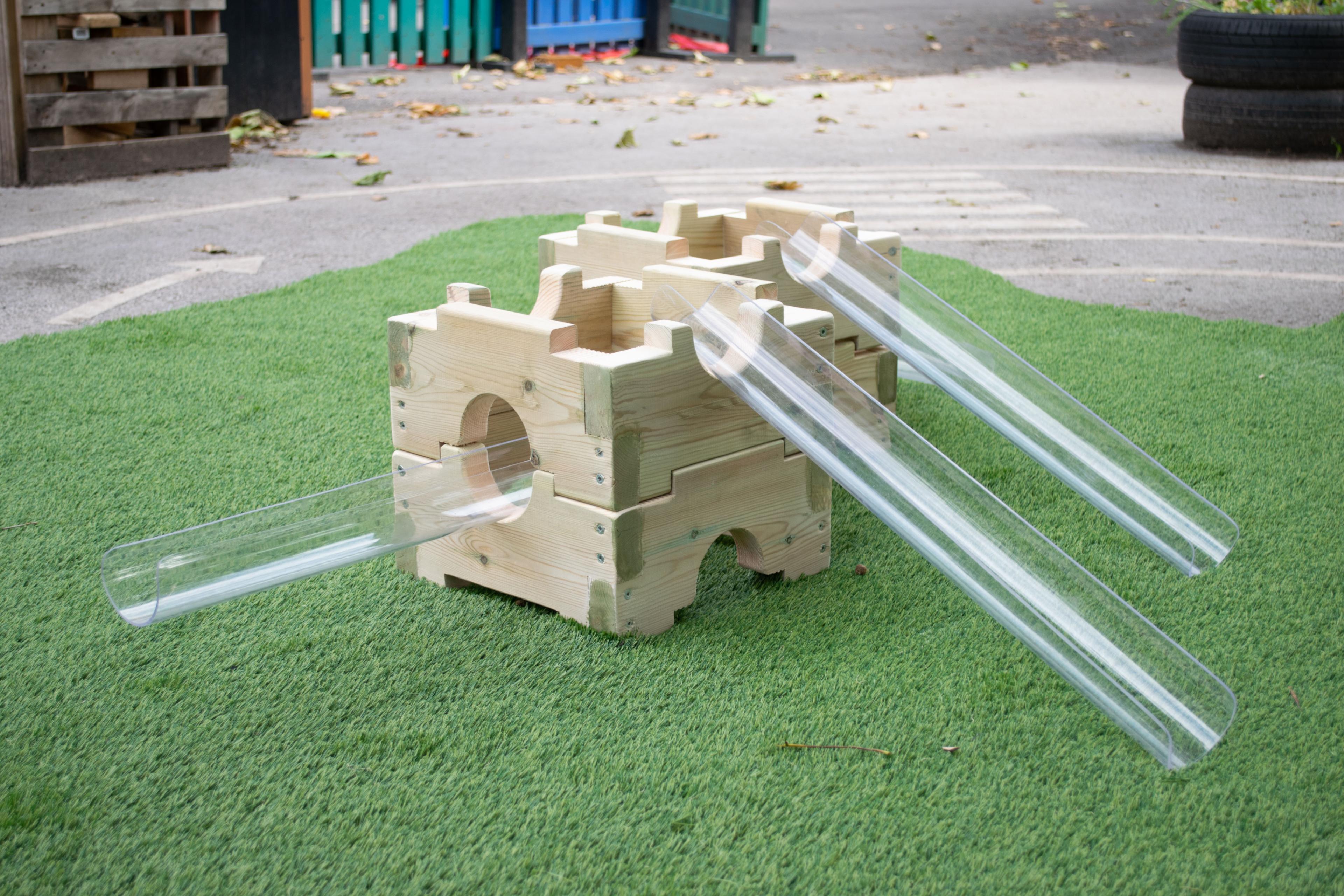 Two wooden blocks that have plastic clear tubes coming off them for the water to run down.
