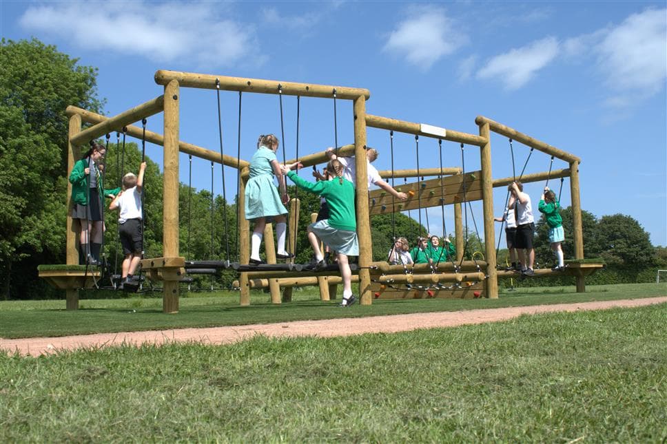 An outdoor climbing frame with 4 areas for children to climb across