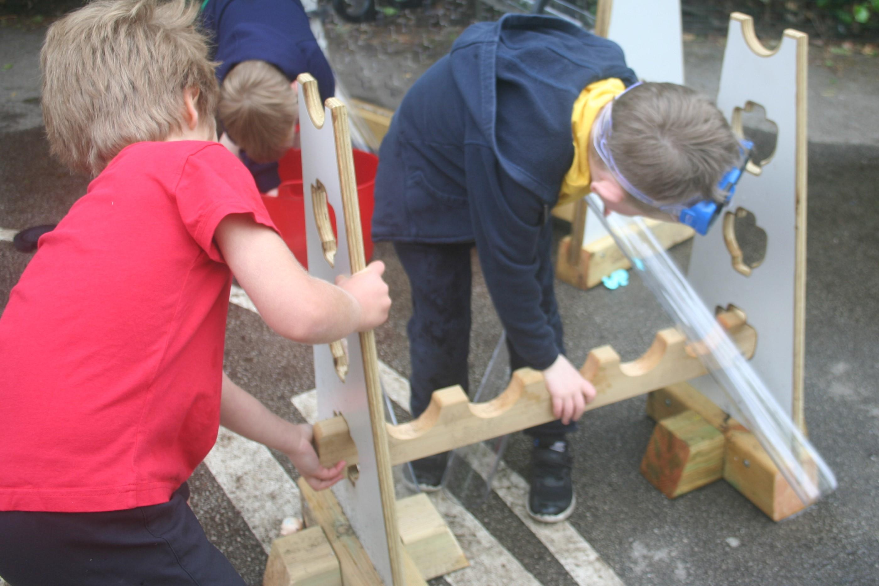 two boys placing the water channels in the stands