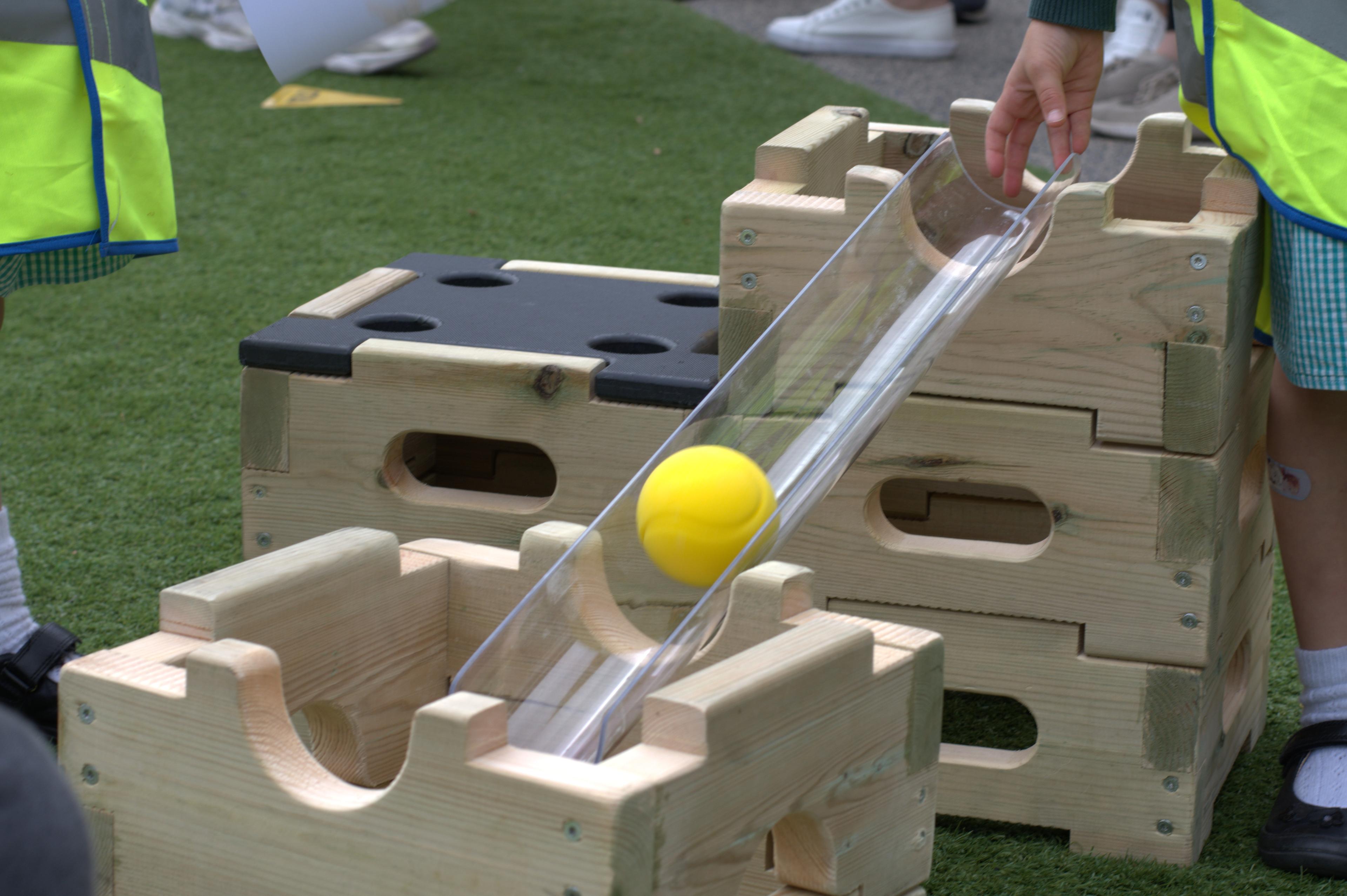 A ball running down the channel  on the play builder