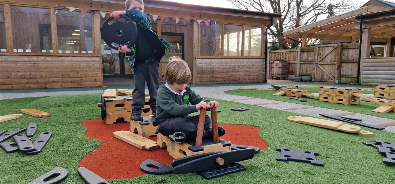 2 young boys pretending to fly a aeroplane in their playground