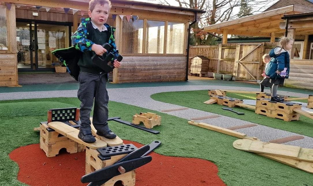 A young boy pretending to be on an aeropplane