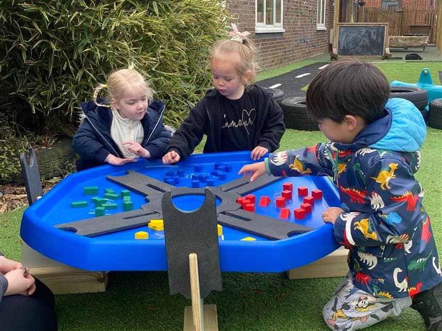 3 children using the sorting sections in their tuff spot tray