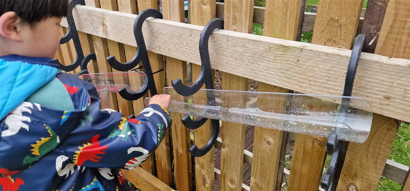 Water channels that hook onto fencing in a school setting
