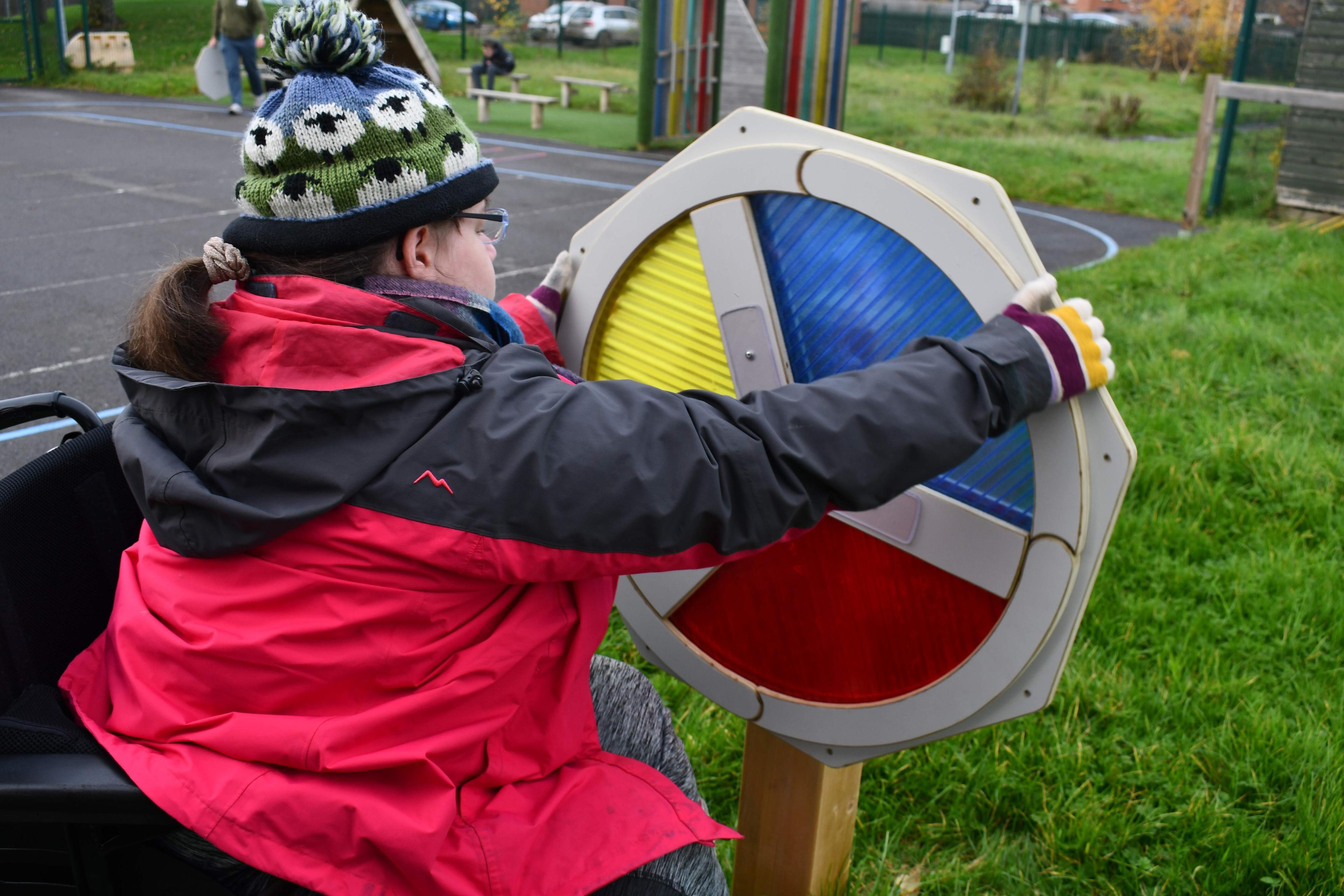 Girl in wheelchair spinning our sensory spinner