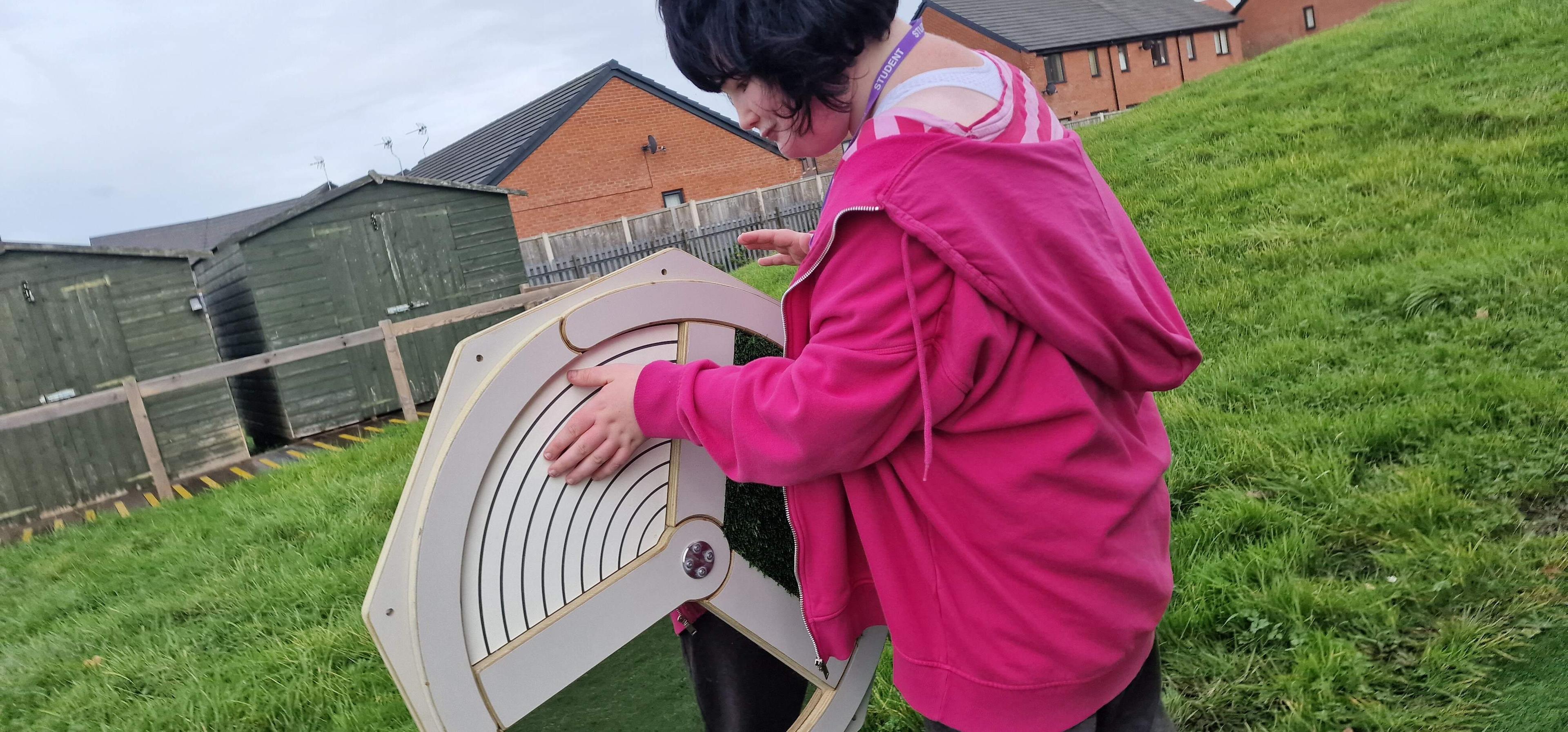 A girl touching the panel on our touch sensory spinner