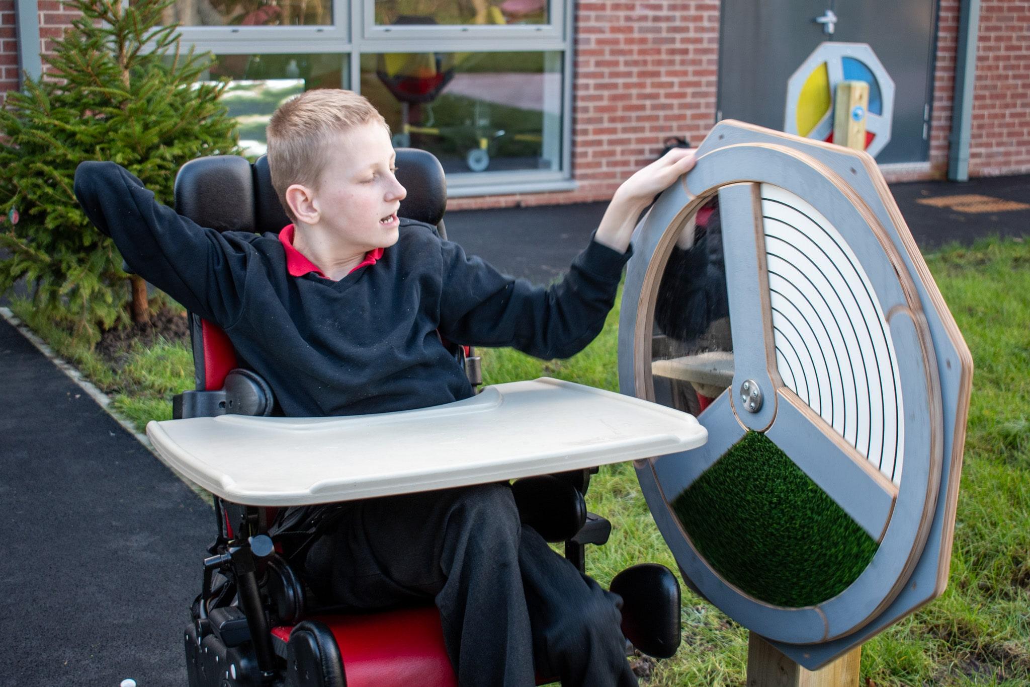 Boy in Wheelchair Playing with Touch Sensory Spinner