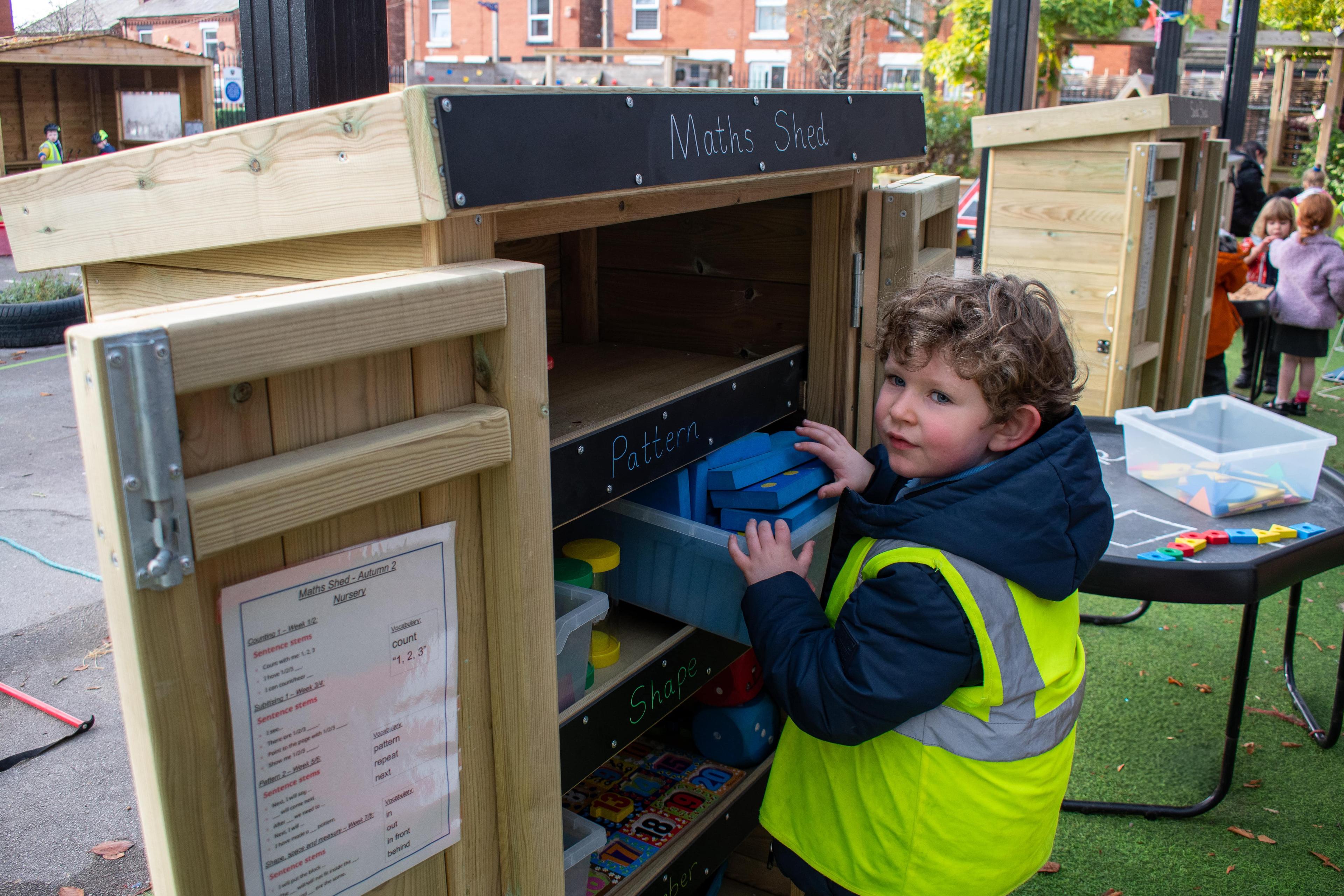 Child Smiling with Acorn Storage Unit