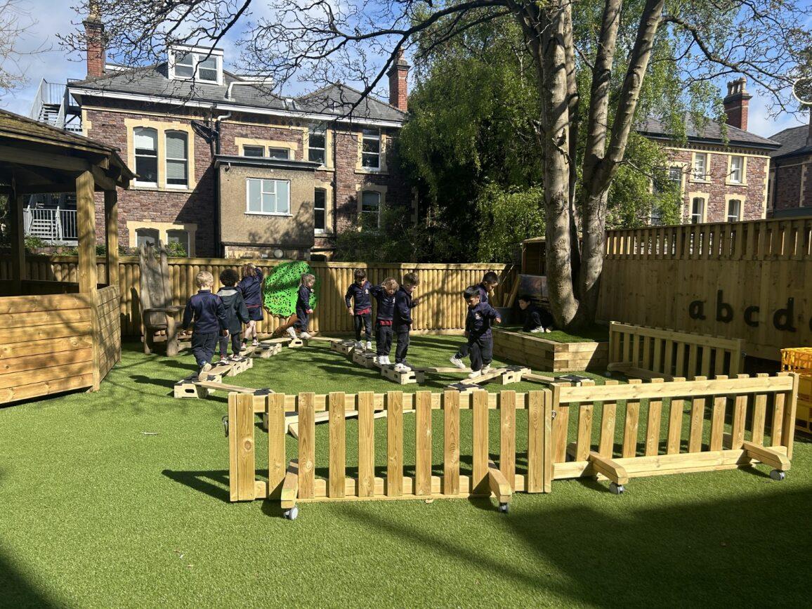 Interactive fence panel on wheels in a playground setting