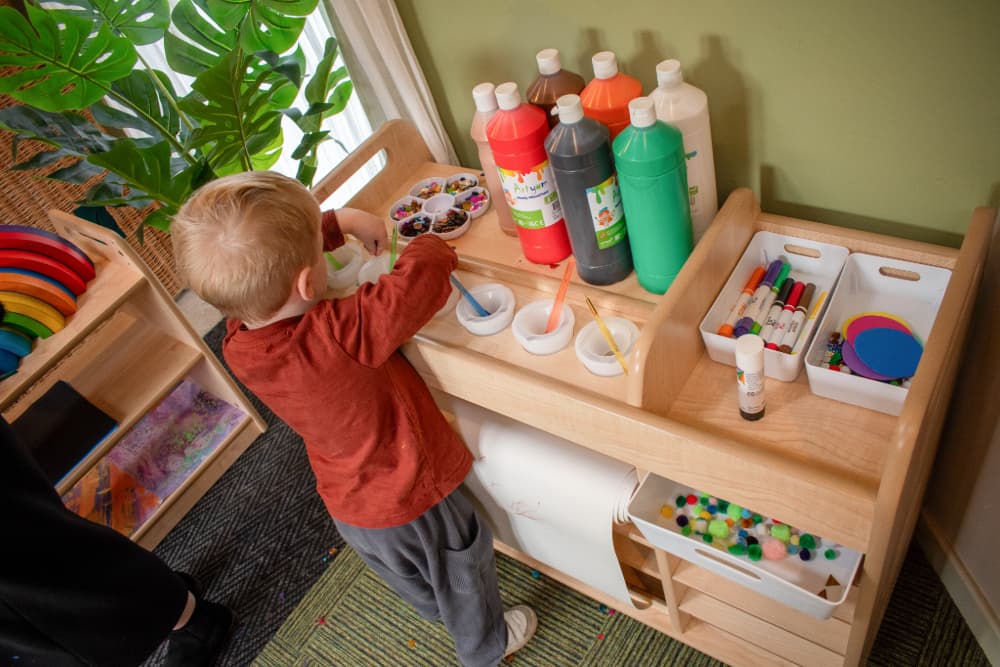 Child engaging with Millhouse Continuous Provision Trolley