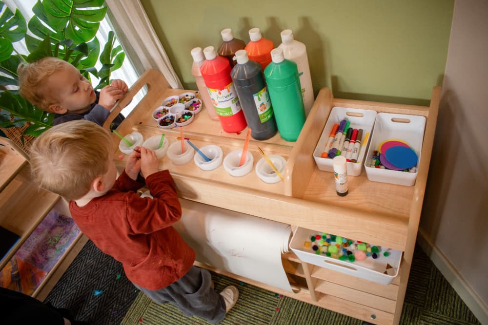 Child looking at Millhouse Continuous Provision Trolley