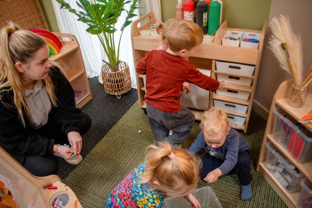 Children opening drawers in Millhouse Expressive Arts & Design Zone