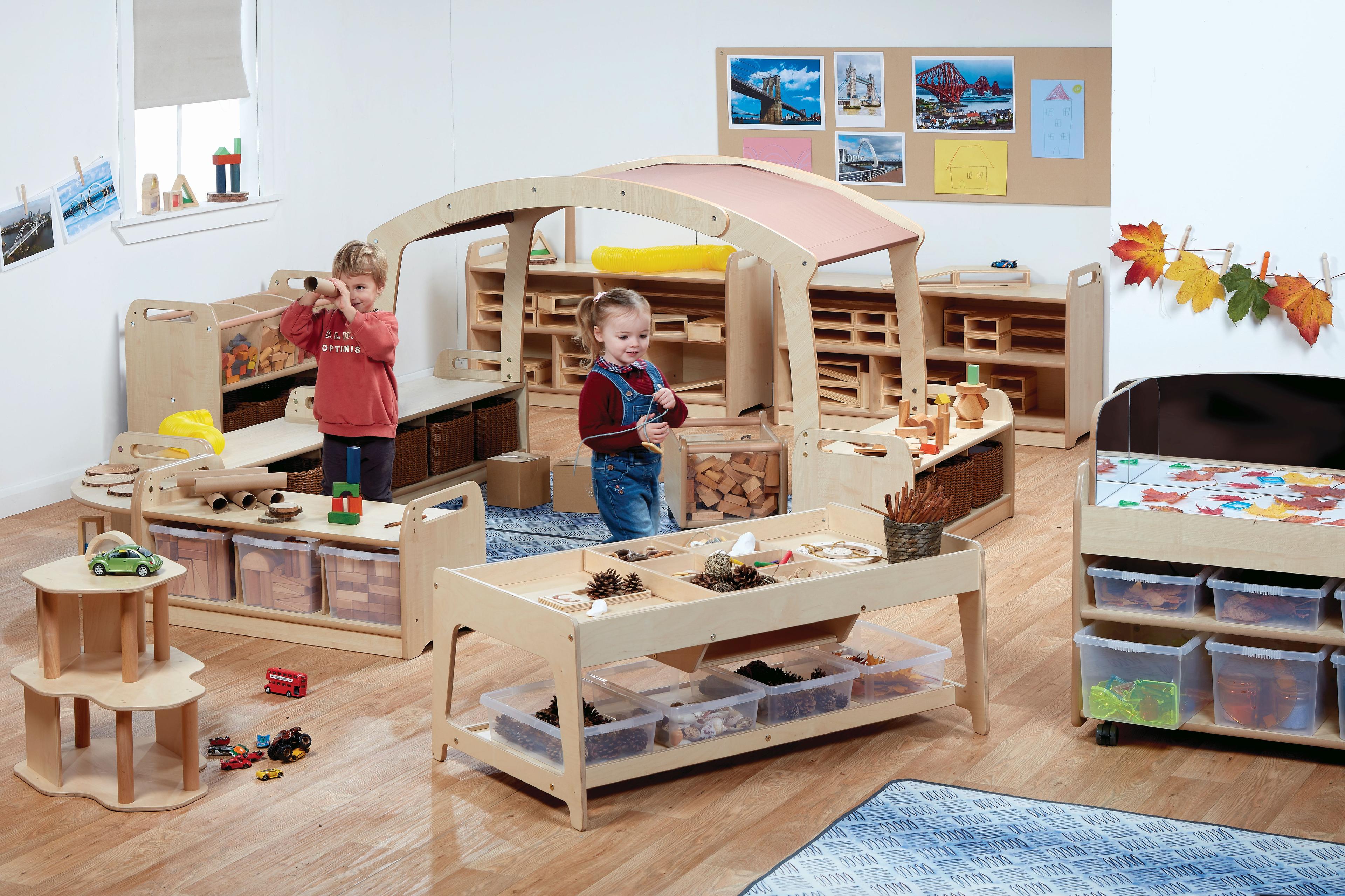 Two pre-school aged children play with different equipment in the STEM Investigation Zone inside a classroom.