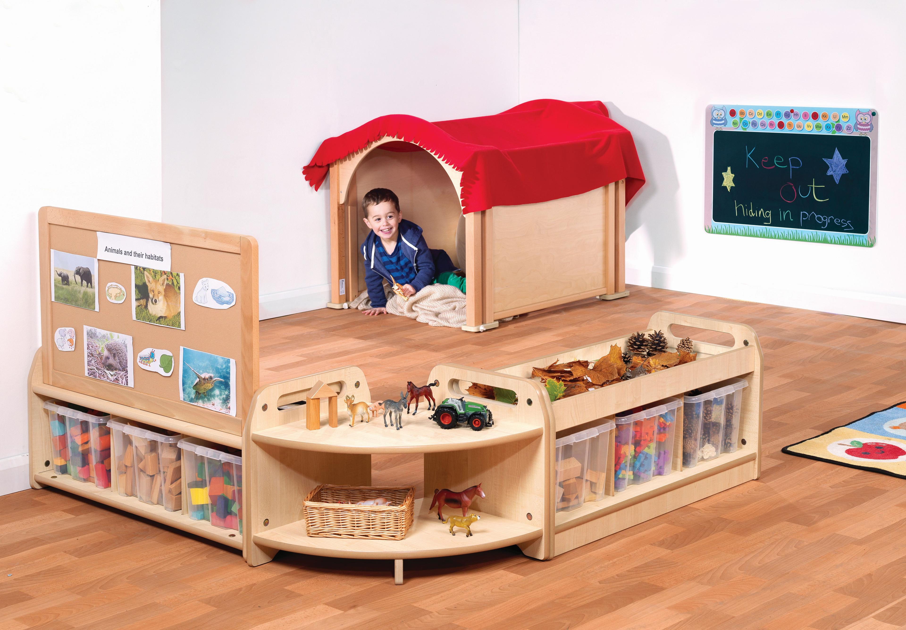 A young boy is hiding in the den which is part of Mini Hide and Seek Zone.
