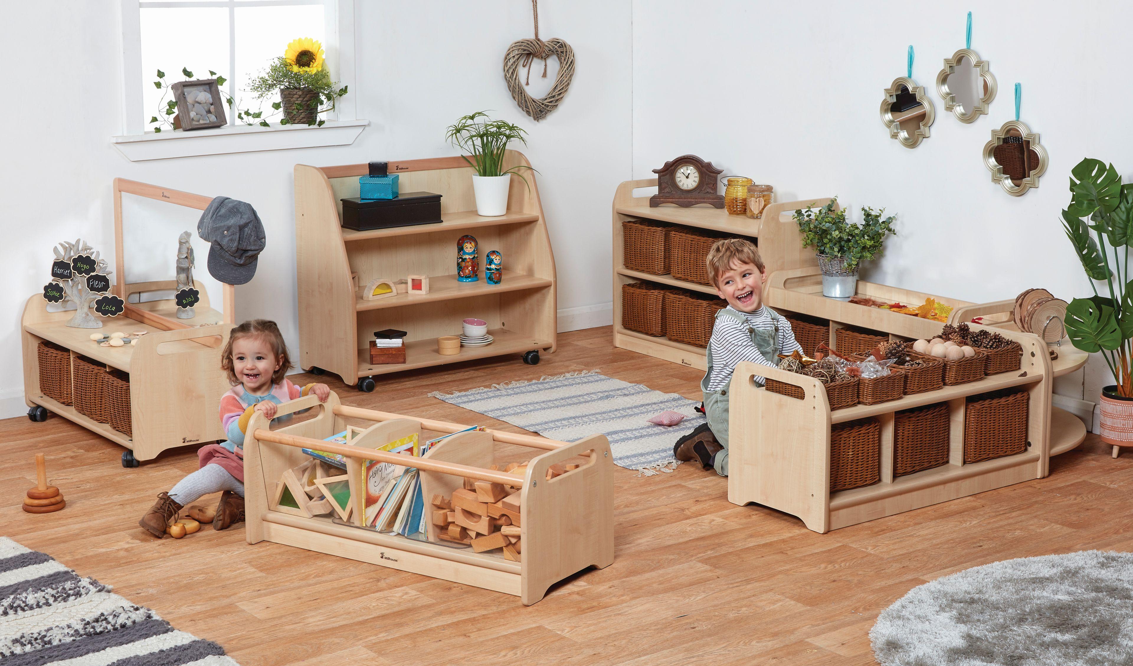 Two happy children playing in the Explorer Zone with Large Baskets inside a classroom.  