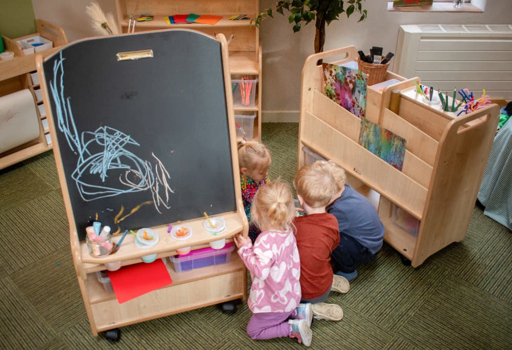 Group of children exploring Millhouse Art Easel