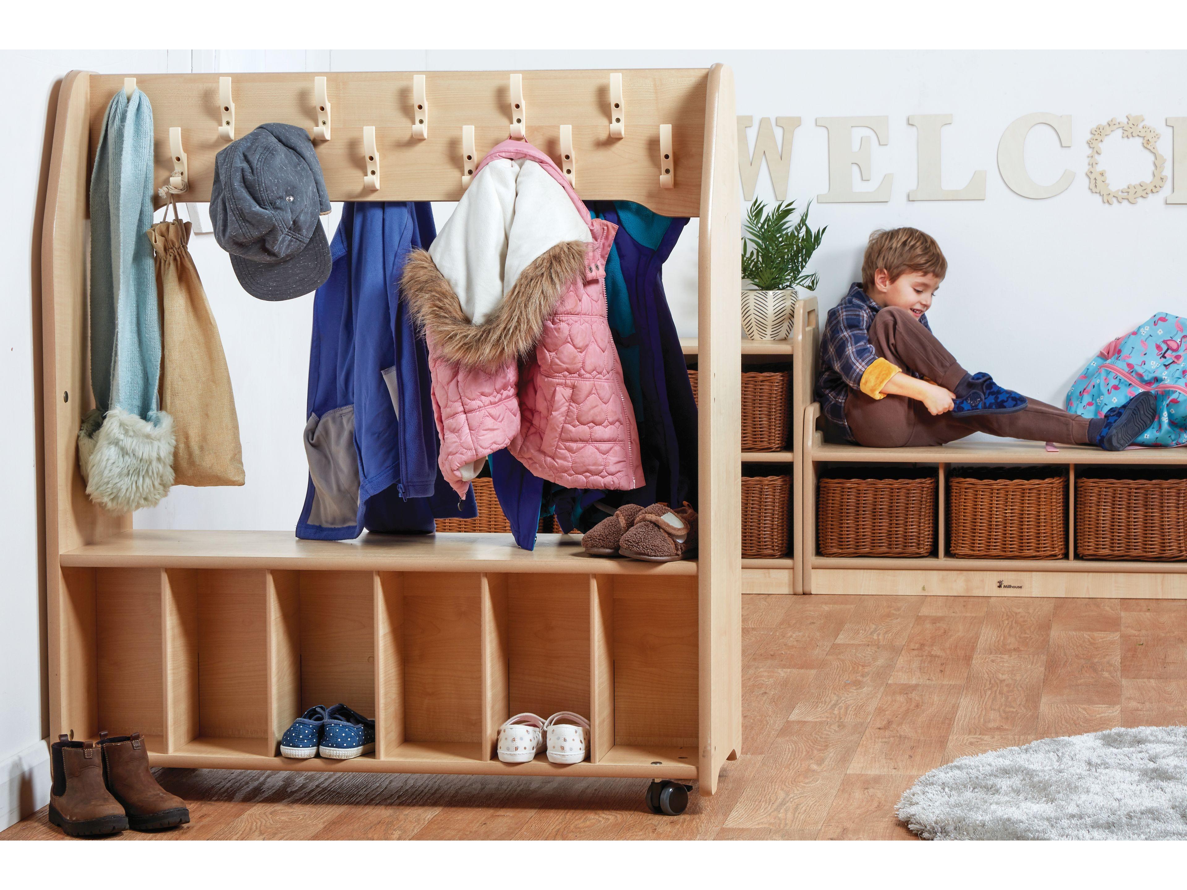 millhouse coat and shoe storage in an eyfs setting with a child getting ready