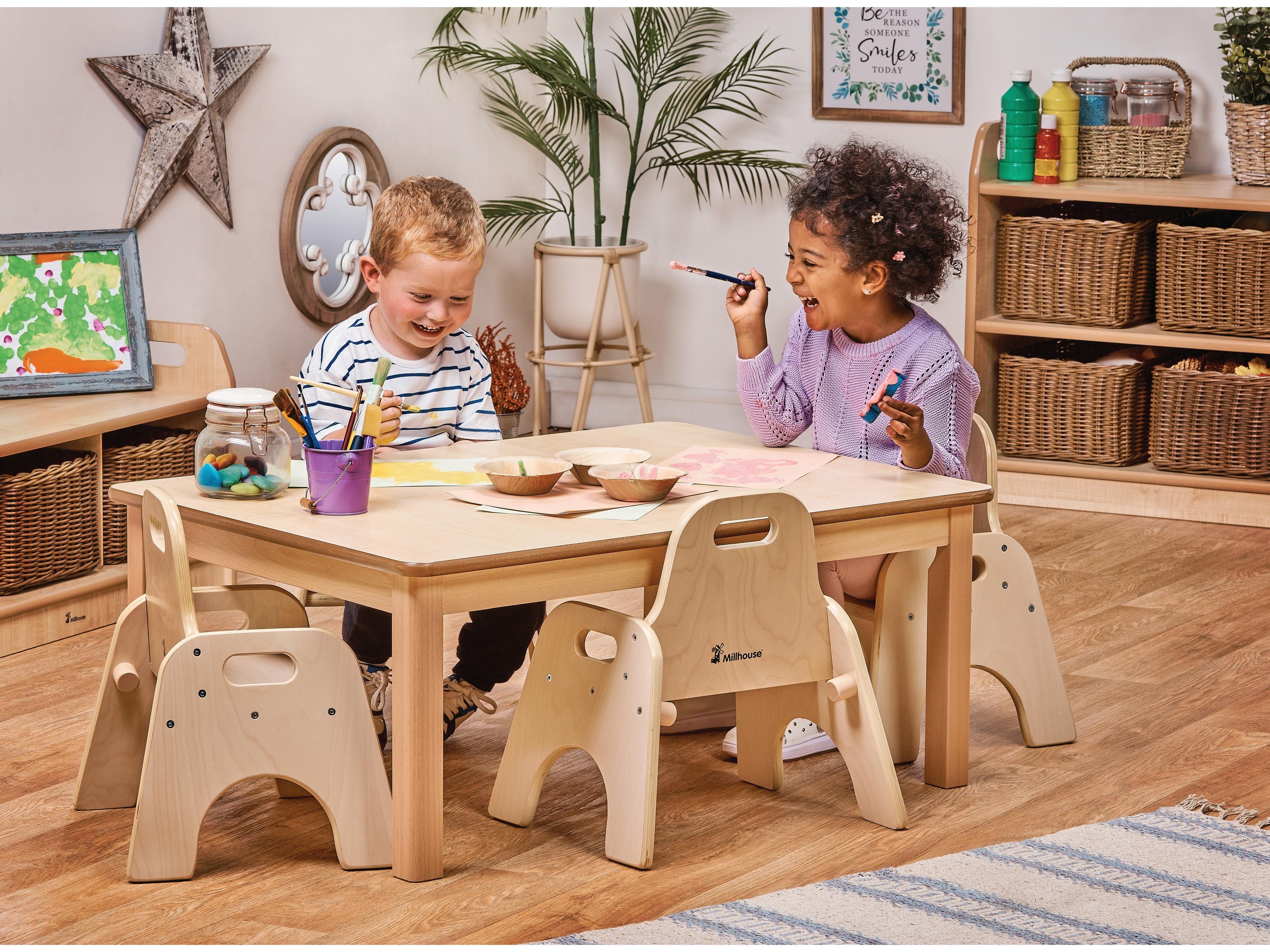 millhouse small low rectangle table with four toddler chairs and children sat painting