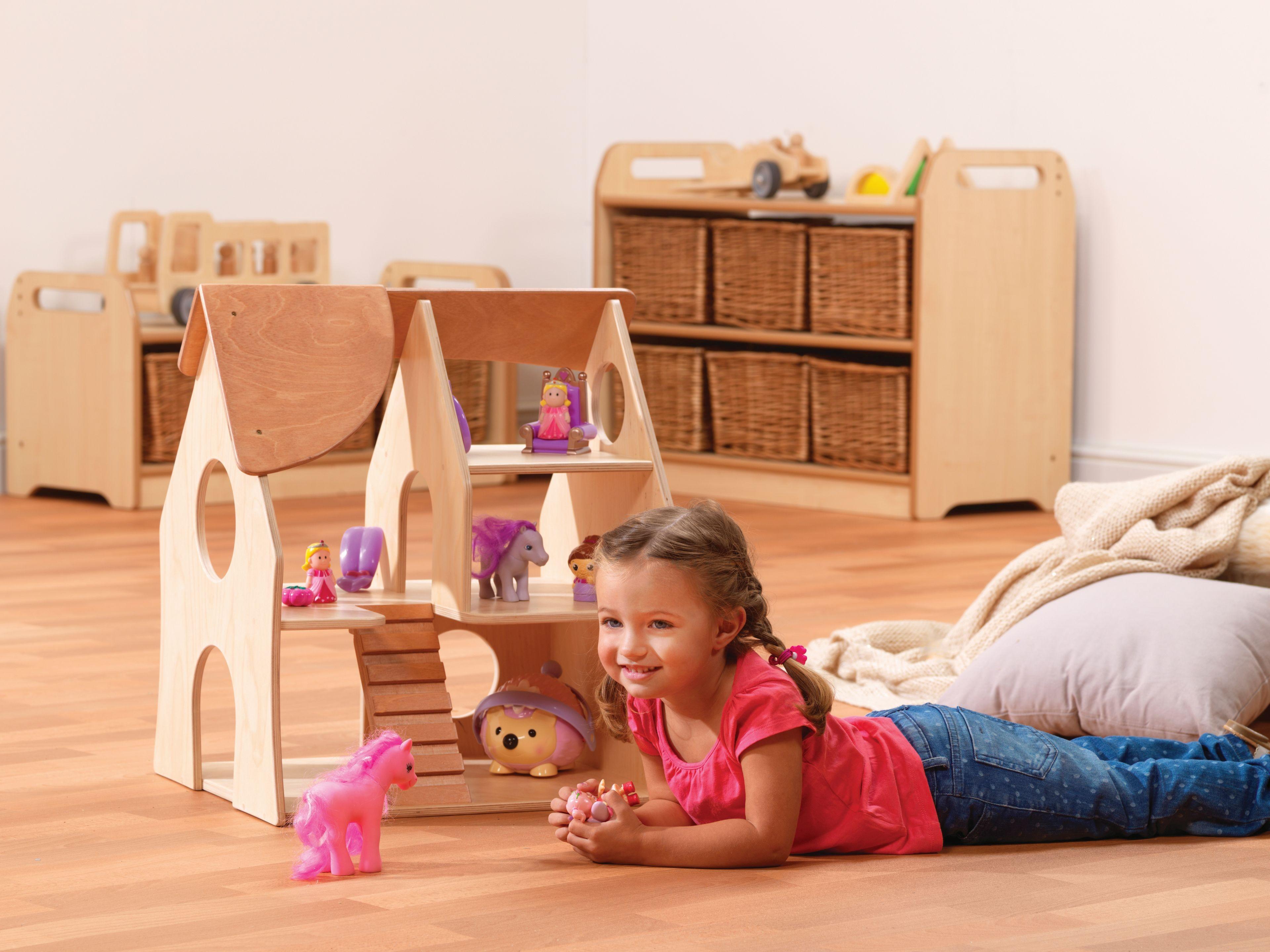 millhouse doll house with child playing next to it