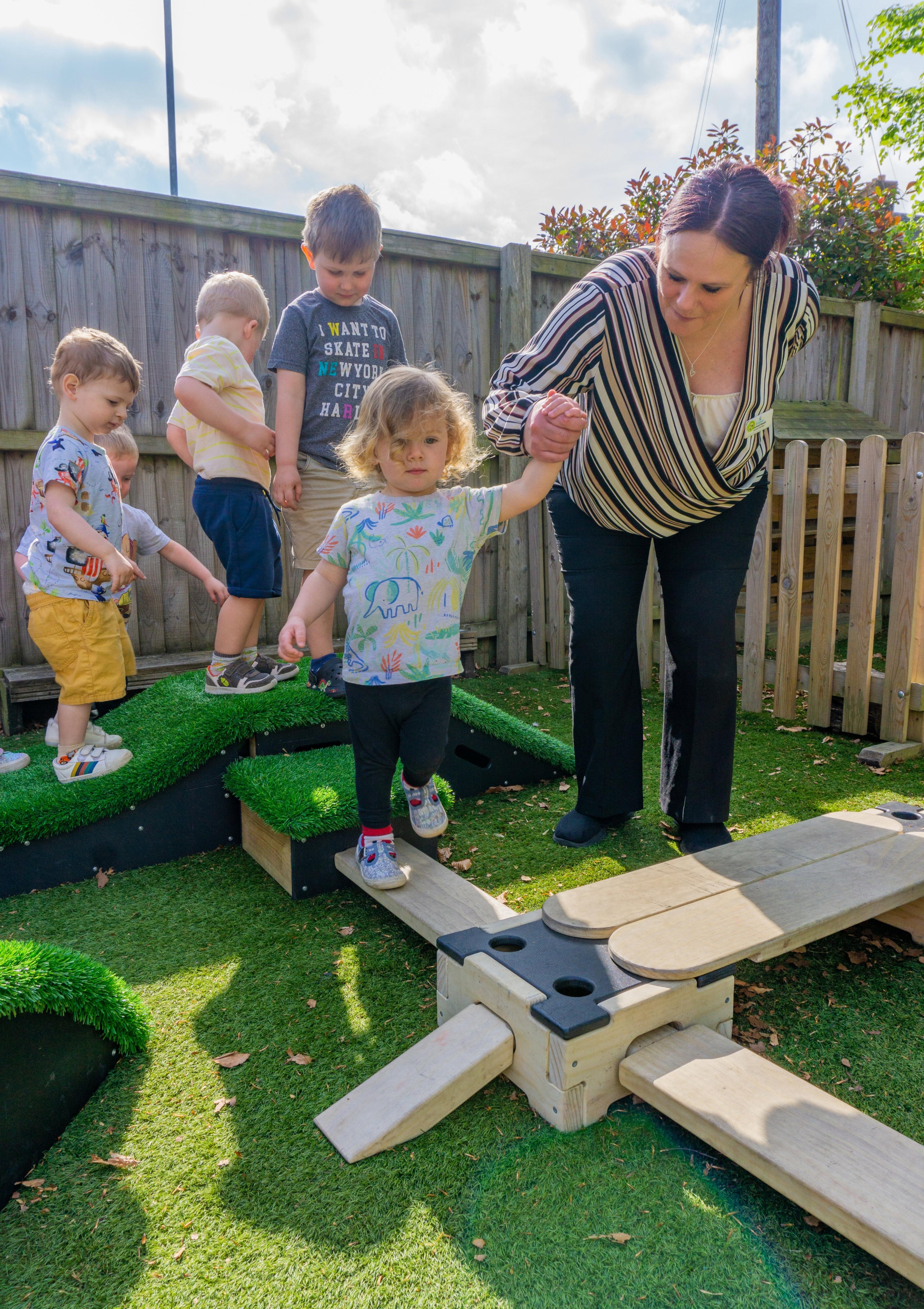 Young boy being assisted through the obstacle course by his teacher
