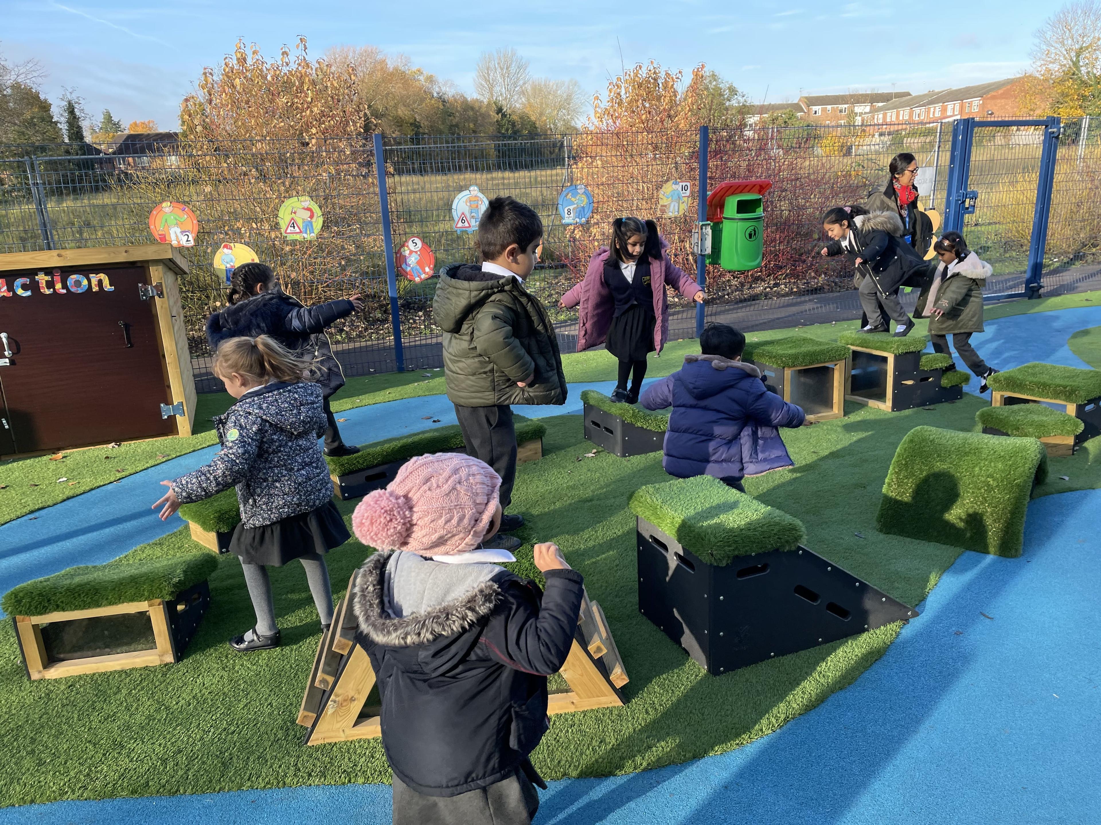 A group of children jumping across ramps and stepping blocks