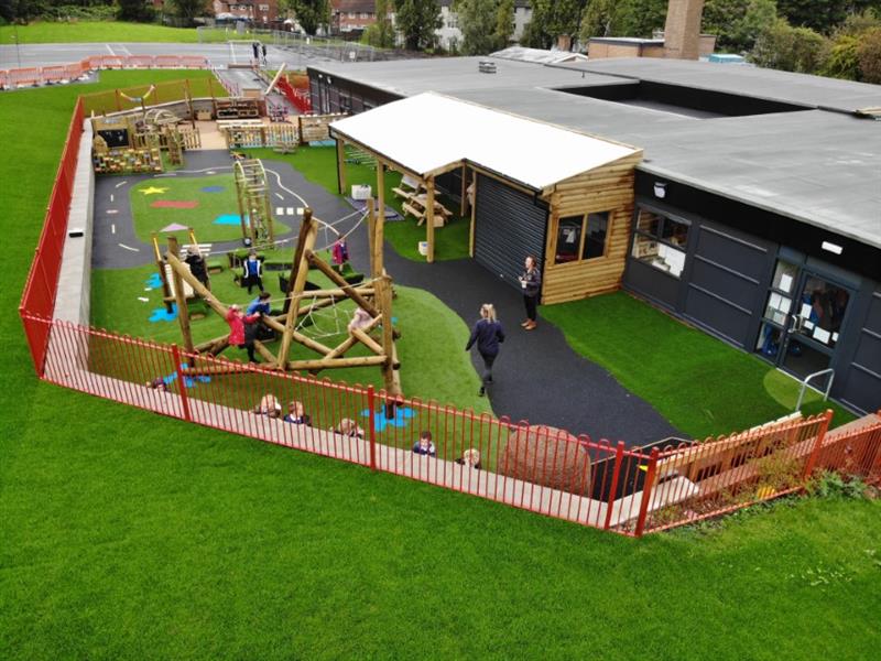 An eyfs playground development created for ryecroft primary academy in leeds featuring a climbing frame, colourful playground surfacing and a huge timber canopy