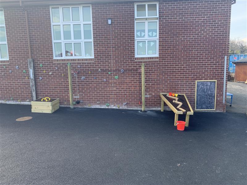 School playground equipment installed against the school building
